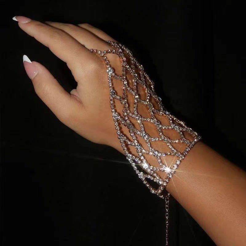 Hand wearing a sparkling bracelet against a black background