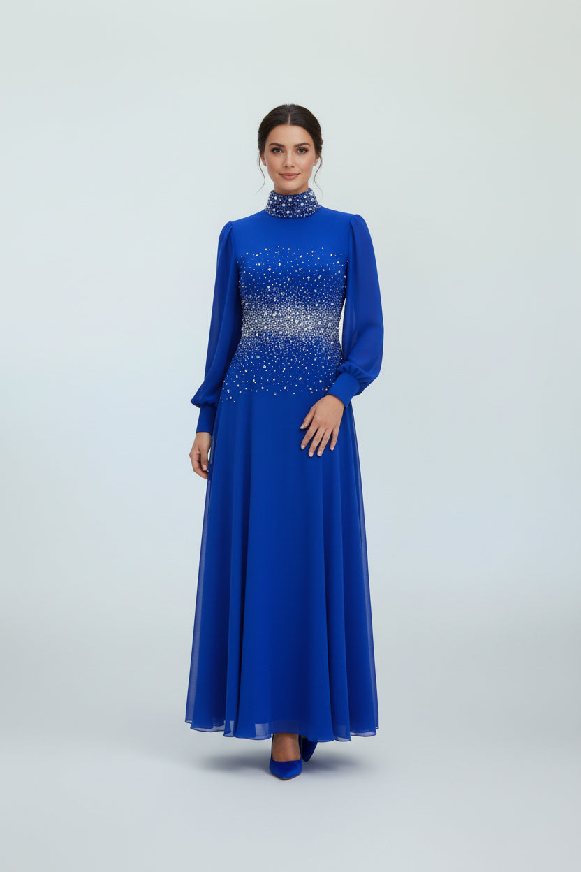Woman wearing a blue dress with intricate detailing on a white background